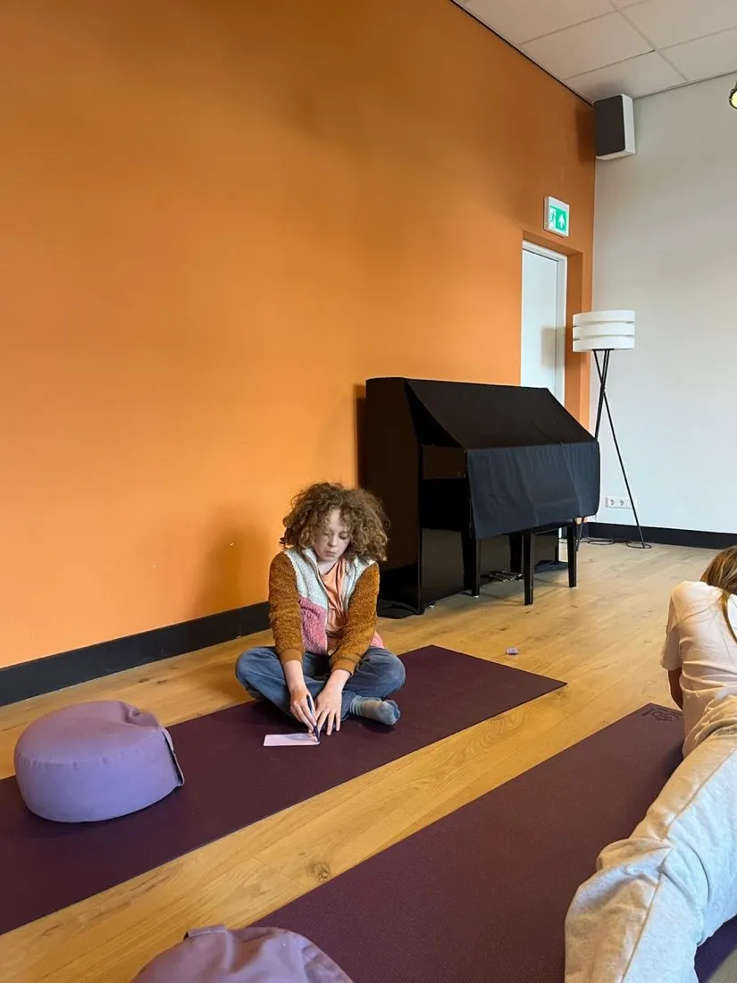 A child writing quietly during a reflection exercise