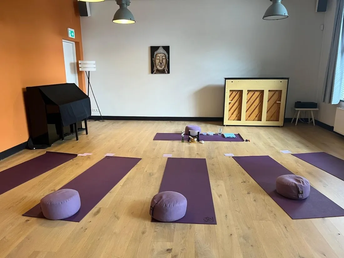The session room set up with mats, cushions and a singing bowl
